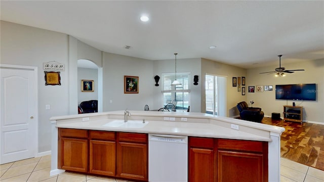 kitchen featuring sink, light tile patterned floors, dishwasher, an island with sink, and pendant lighting