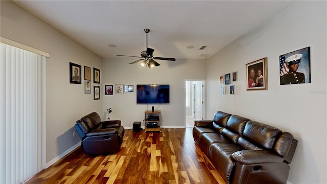 living room featuring wood-type flooring and ceiling fan