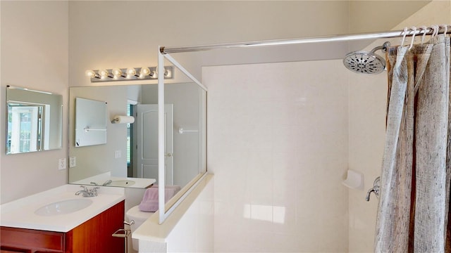 bathroom featuring walk in shower, vanity, and toilet