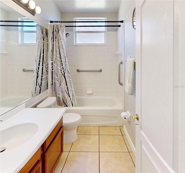 full bathroom with tile patterned flooring, vanity, shower / tub combo, toilet, and a textured ceiling