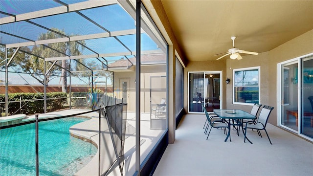 view of swimming pool with a lanai, ceiling fan, and a patio area