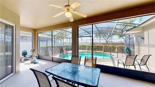 sunroom / solarium featuring ceiling fan