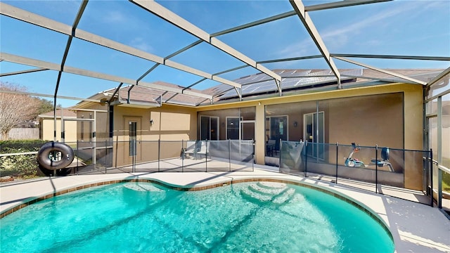 view of swimming pool featuring a patio and glass enclosure