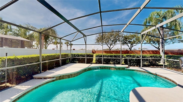 view of pool with glass enclosure