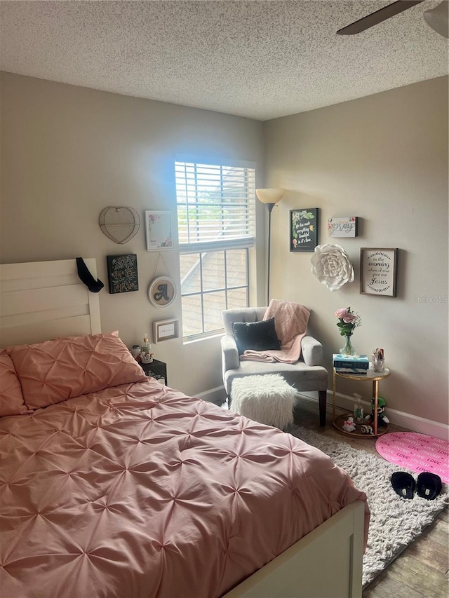 bedroom with a textured ceiling and ceiling fan