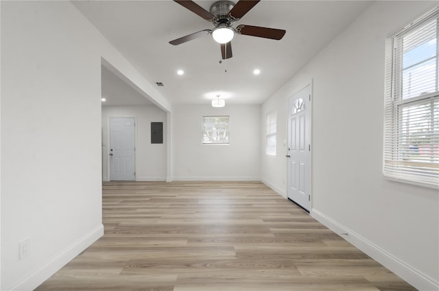 empty room with light wood-style flooring, recessed lighting, a ceiling fan, baseboards, and electric panel