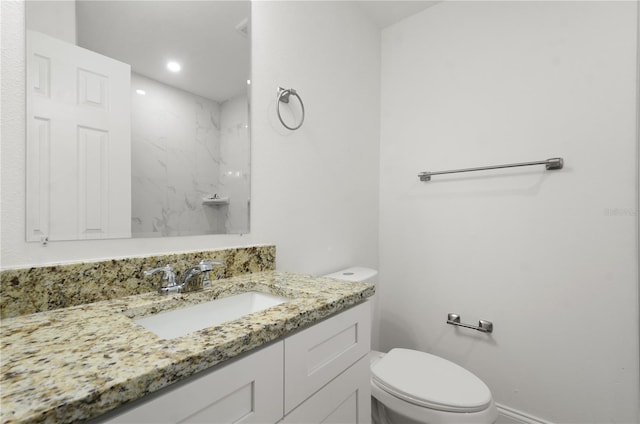 bathroom featuring toilet, recessed lighting, and vanity