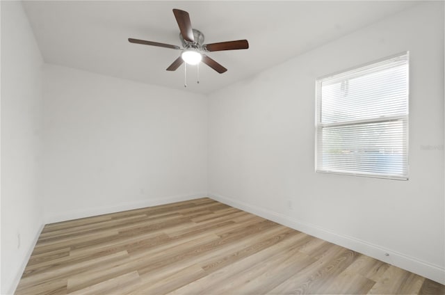 empty room with light wood-style flooring, baseboards, and a ceiling fan