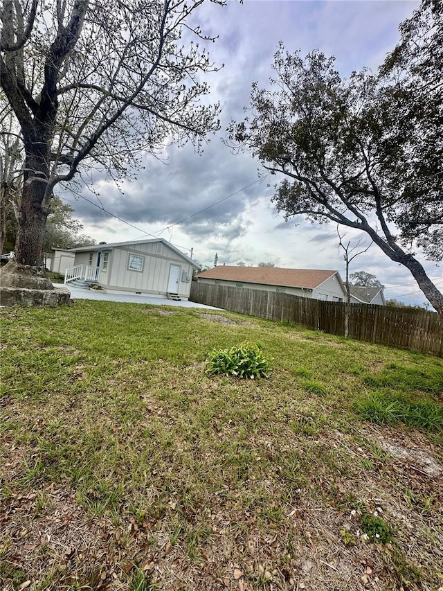 view of yard with fence and a patio