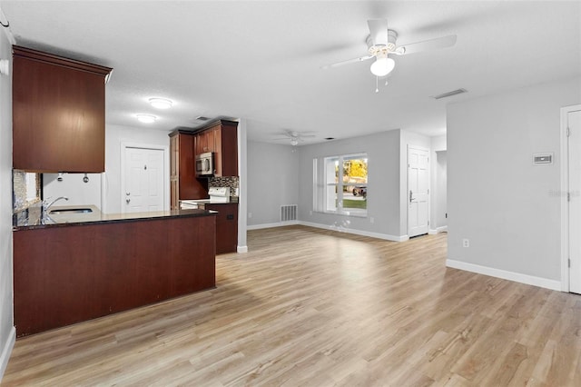 kitchen with decorative backsplash, a textured ceiling, sink, light hardwood / wood-style flooring, and white electric range