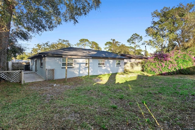 back of house featuring a yard and a patio