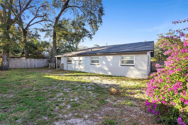 rear view of property with a yard