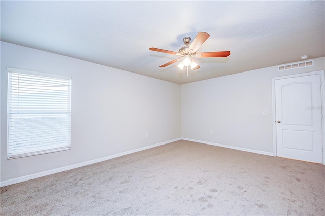 empty room with carpet flooring and ceiling fan