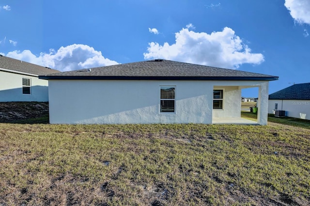 view of home's exterior featuring central AC, a patio, and a lawn