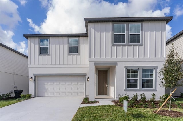 view of property with a front lawn and a garage