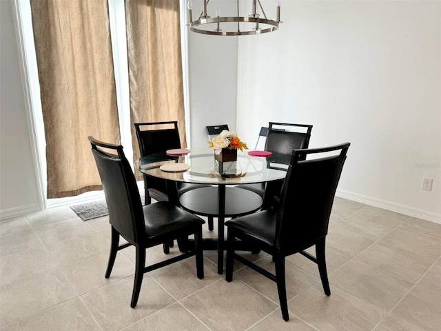 tiled dining room with an inviting chandelier