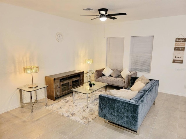 tiled living room with ceiling fan