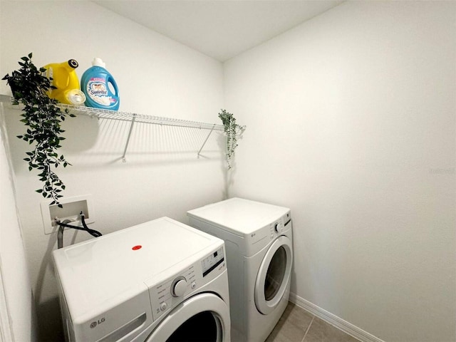 washroom featuring washer and dryer and light tile patterned floors