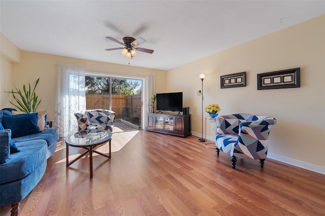 living room featuring ceiling fan and wood-type flooring