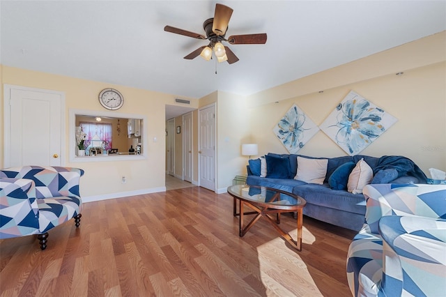 living room featuring ceiling fan and light hardwood / wood-style floors