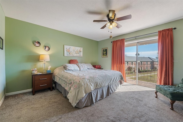 bedroom with carpet, ceiling fan, access to exterior, and a textured ceiling