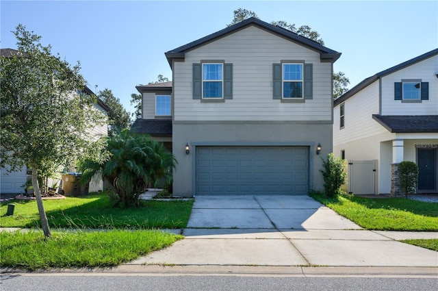 view of property with a front yard and a garage