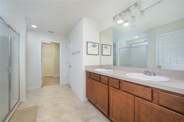 bathroom featuring tile patterned floors, vanity, and an enclosed shower