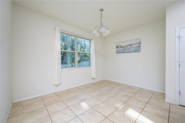 tiled empty room with a chandelier