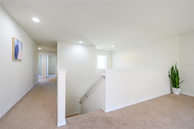 hallway with light colored carpet