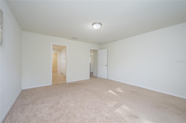 unfurnished room featuring light colored carpet