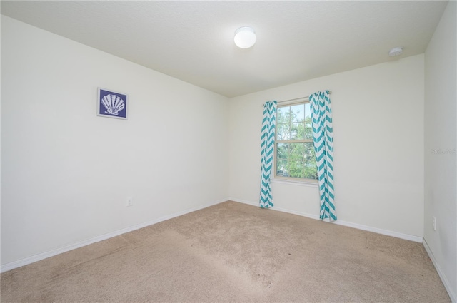 empty room featuring light carpet