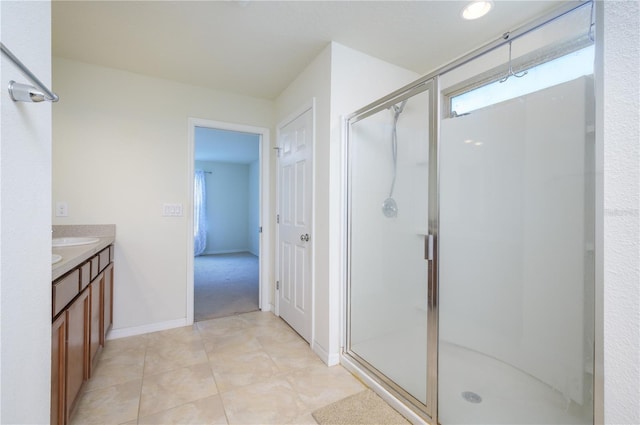 bathroom featuring vanity, a healthy amount of sunlight, and a shower with shower door