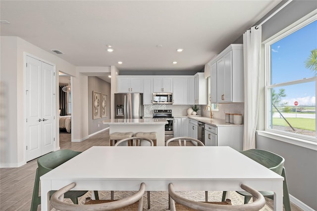 dining room featuring sink and light hardwood / wood-style flooring