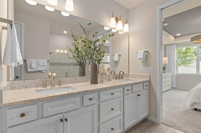 bathroom featuring vanity and a shower with shower door