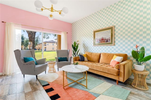 living room with hardwood / wood-style flooring and a notable chandelier