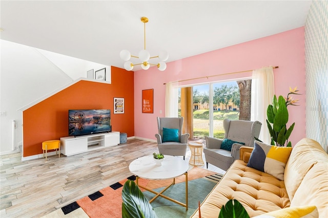 living room with an inviting chandelier and light wood-type flooring