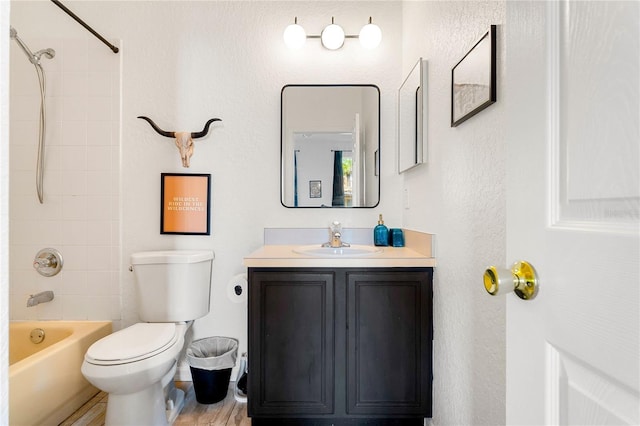 full bathroom with vanity, toilet, and tiled shower / bath combo