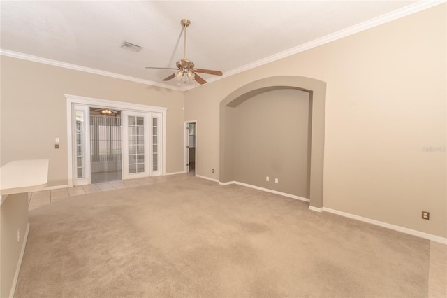 unfurnished room featuring ceiling fan, light colored carpet, and crown molding