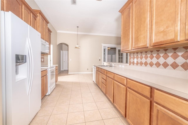 kitchen with white appliances, backsplash, crown molding, sink, and hanging light fixtures