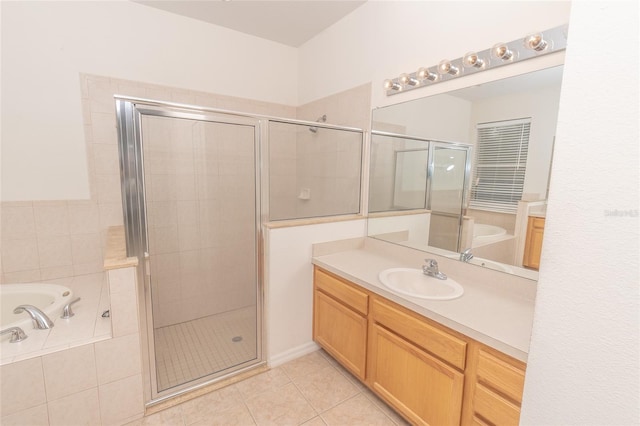 bathroom featuring tile patterned flooring, shower with separate bathtub, and vanity