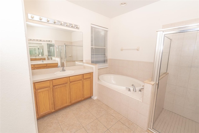 bathroom with tile patterned floors, vanity, and independent shower and bath