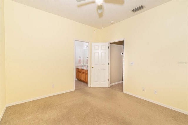 empty room featuring ceiling fan and light colored carpet