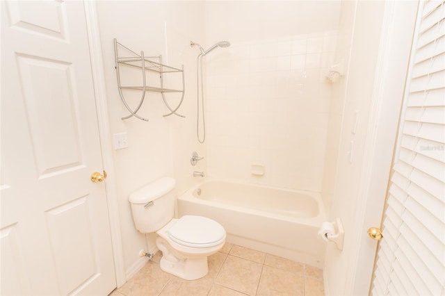 bathroom with tile patterned flooring, toilet, and shower / washtub combination