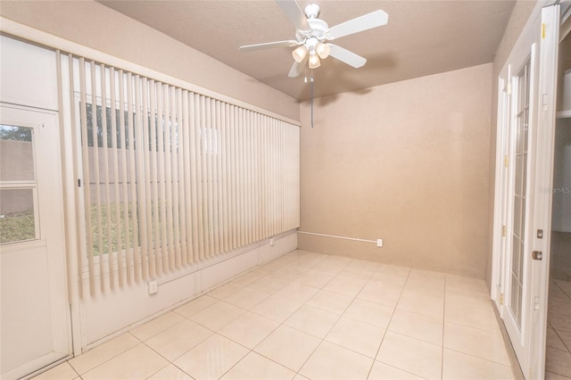 tiled empty room with ceiling fan