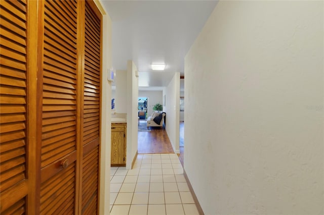 hall with light tile patterned floors