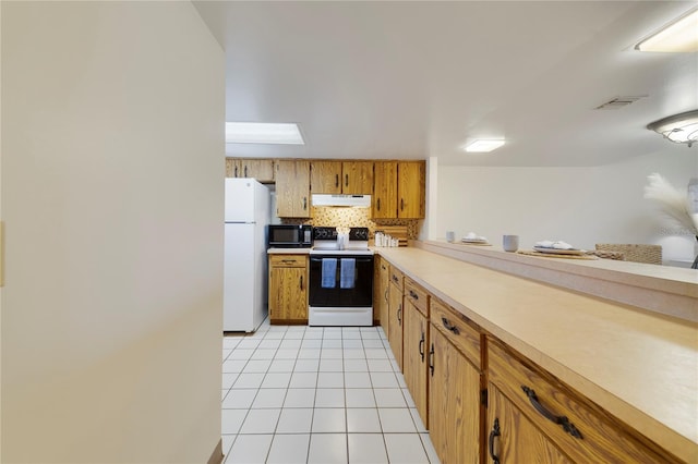 kitchen with white appliances, visible vents, decorative backsplash, under cabinet range hood, and light tile patterned flooring