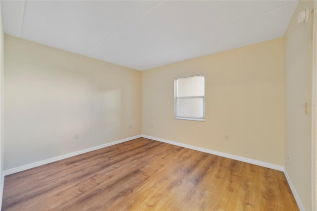 unfurnished room featuring light wood finished floors and baseboards