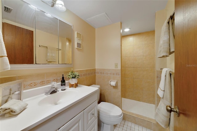 full bath featuring tile walls, toilet, vanity, tile patterned flooring, and walk in shower