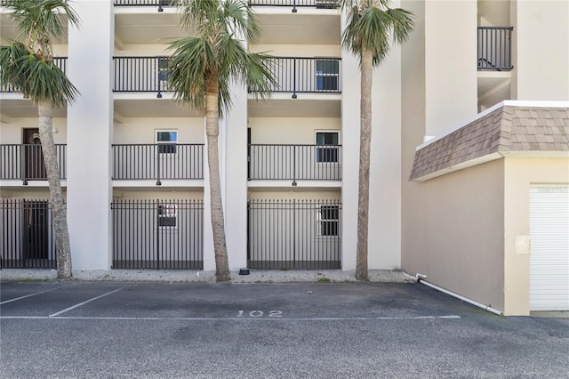 view of building exterior with uncovered parking