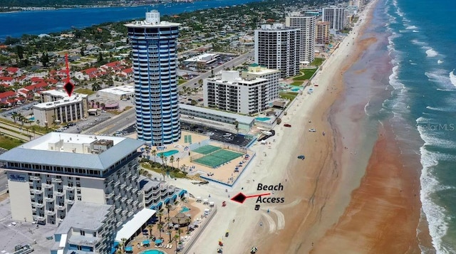 aerial view featuring a water view, a view of city, and a beach view